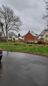 a puddle of water on a street next to a house at Double Bedroom in converted garage-No shower,bath facility in Bristol