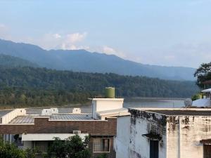 a building with a view of a lake and mountains at A radiant villa on Ganges with modern amenities in Rishīkesh