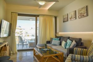 a living room with a couch and a table at Filia Luxury Apartments in Chania Town