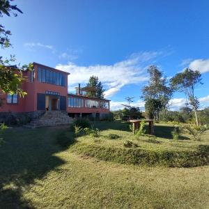 a red house with a picnic table in front of it at Vallombre natiora 