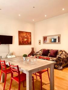 a living room with a table and chairs and a couch at Roma Da Noi Suite in Rome