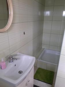 Baño blanco con lavabo y bañera en Świętokrzyski Zakątek Porąbki 111a 26-004 Bieliny en Bieliny