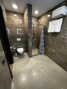 a bathroom with a shower and a toilet at Rasoda Hotel&Restaurant in Tashkent