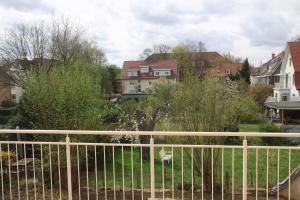 a fence in front of a yard with houses at Biopension Satya in Offenburg