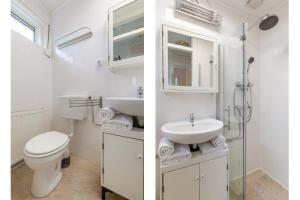 un bagno bianco con un water e un lavandino di Welcome in - Koekoeksbloemwei 90, Kortgene a Kortgene Altre 18 foto