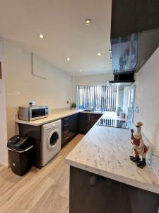 a kitchen with a counter top with a dishwasher at Stunning Gem detached with drive in High Hazels