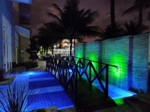 a wall with blue and green lights on it at Porto Marina Mont Blanc Resort II in Mangaratiba