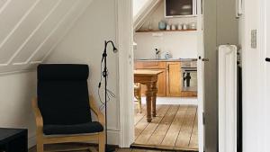 a kitchen with a table and a chair and a desk at ApartmentInCopenhagen Apartment 298 in Copenhagen