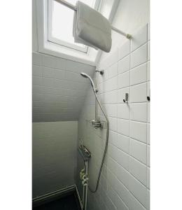 a shower in a bathroom with a window at ApartmentInCopenhagen Apartment 298 in Copenhagen