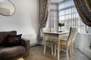 a living room with a table and chairs and a couch at Serene Cottage in Wolsingham, Sleeps 6 in Bishop Auckland