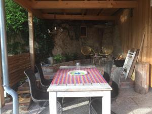 a wooden table and chairs on a patio at Ferienhaus Andadoana in Kelheim