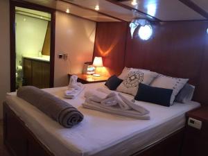 a bedroom with a large bed with towels on it at AsterixYacht-navigate to Greece,Turkey and so more in Marmaris