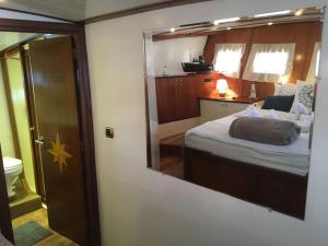 a bedroom with a bed and a mirror on the wall at AsterixYacht-navigate to Greece,Turkey and so more in Marmaris