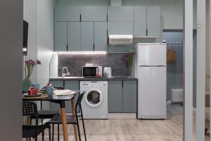 a kitchen with a refrigerator and a washing machine at Апартаменты Comfort Life 91 in Almaty