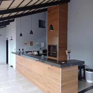 a large kitchen with a counter top in a room at Casa de lazer km eventos in Uberaba