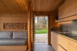 a view of the kitchen of a tiny house at Casera Pian Grand Wellness Lodge in Chies dʼAlpago