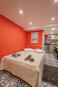 a bedroom with a large bed with orange walls at Casa Lefteritsa in Corfu