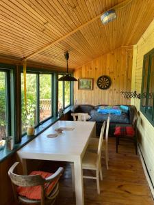 a room with a table and chairs and a bed at Summerhouse Labanoras in Stirniai
