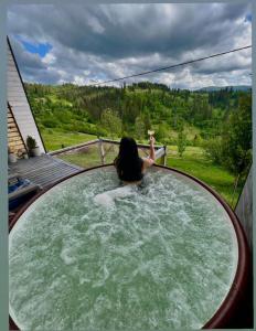 a woman is in a pool of water at Карпатське Hygge in Slavske