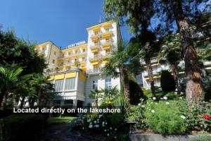 a building located directly on the lake shore at Golf Hotel René Capt in Montreux