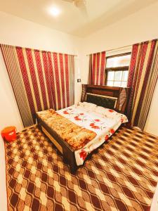 a bedroom with a bed and a checkered floor at Sea Green Guest House in Srinagar