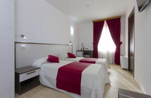 A bed or beds in a room at Resort Santa Maria Hotel