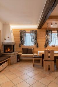 a living room with a fireplace and a table at Casera Moda Luxury Chalet in Chies dʼAlpago