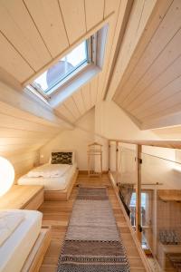 a bedroom with a bed and a skylight at Casera Moda Luxury Chalet in Chies dʼAlpago