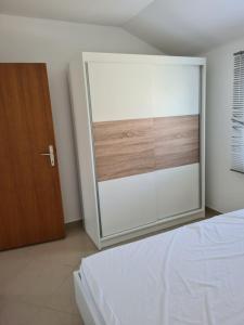 a bedroom with a sliding glass door and a bed at Apartments Ivan in Povljana