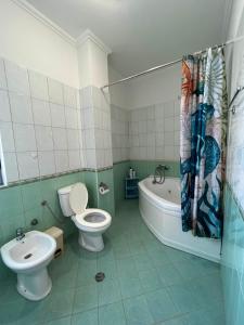a bathroom with a toilet and a tub and a sink at Apartment Kune,Shëngjin in Shëngjin +24 photos
