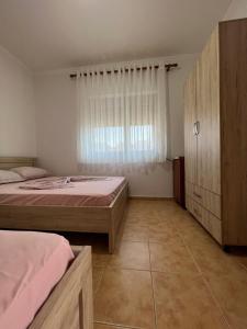 a bedroom with two beds and a window at Apartment Kune,Shëngjin in Shëngjin