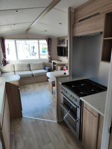 a kitchen and living room of a caravan at Haven Holiday Park 3 bedroom Cala Gran Fleetwood in Thornton