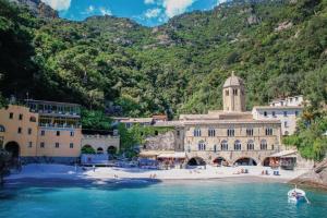 a building on a beach next to a body of water at [Vista Mare Portofino] Terrazza • Free Parking • Wi-fi in Rapallo