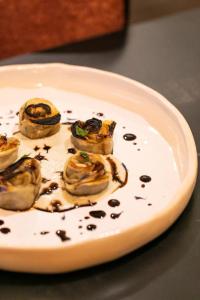 a plate of oysters with sauce and chocolate on a table at Bhr Cavour 150 in Rome