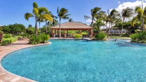 a large swimming pool with a gazebo and palm trees at 3Bd Kamilo 349 Home At Mauna Lani Resort in Waikoloa