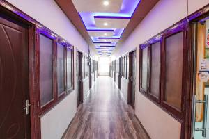 a corridor with a hallway with a blue ceiling at FabExpress Shree Karuna in Transport Nagar