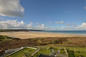 a view of a beach with the ocean in the background at Sandy Bay Apartment, St Ives Bay, Hayle in Hayle