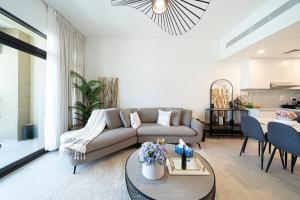 a living room with a couch and a table at Classy One Bed, Burj Al Arab View, Beach Access in Dubai