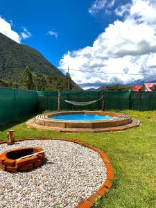 a small swimming pool in a yard with a fence at Cabaña Alpina SEAL in Oxapampa