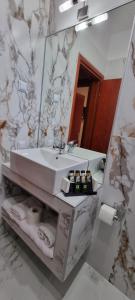 a bathroom with a sink and a mirror at PREMIUM SUITES in Ofrínion