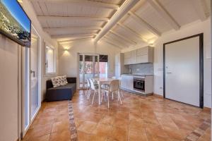 a kitchen and living room with a table and chairs at Stella Marina- Luxury Sea View in Porto Cervo! in Porto Cervo