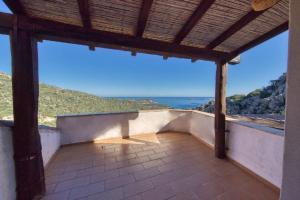 a porch of a house with a view of the ocean at Stella Marina- Luxury Sea View in Porto Cervo! in Porto Cervo