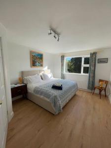 a bedroom with a bed and a wooden floor at Newly renovated Cottage with private trout fishing set in beautiful wildlife estate in Monaghan