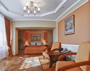 a hotel room with a bed and a table and chairs at Hetman Hotel in Lviv