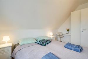 a bedroom with a bed with blue pillows on it at LOVELY TOP FLOOR Apart COPENHAGEN NEAR AIRPORT, METRO AND THE BEACH in Copenhagen