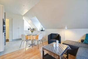 a living room with a couch and a table at LOVELY TOP FLOOR Apart COPENHAGEN NEAR AIRPORT, METRO AND THE BEACH in Copenhagen