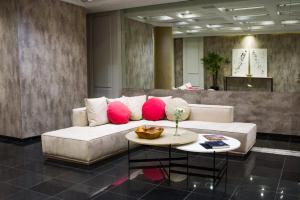 a living room with a couch with pink pillows at 1253 Recoleta Small Hotel in Buenos Aires