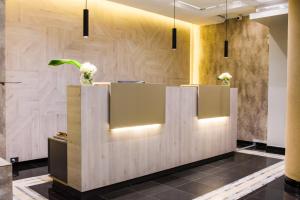 a lobby with a reception desk with flowers on it at 1253 Recoleta Small Hotel in Buenos Aires