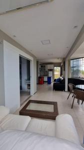 a large living room with a couch and a table at Apartamento pé na areia in São Luís