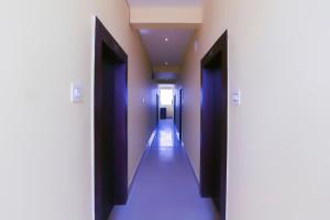 a corridor of a hallway with purple doors and ceilings at OYO Hotel Shree Balajee 1 in Puri